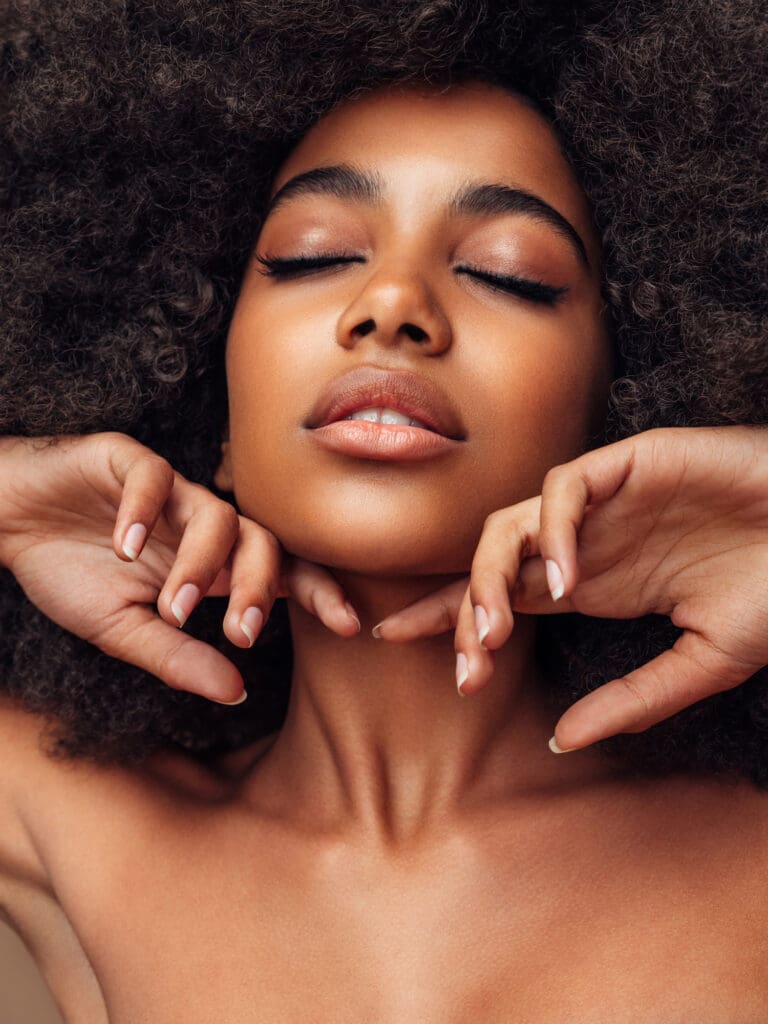Woman's hands framing her jawline on the skin tightening page, Pittsford, NY med spa